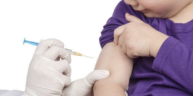 The doctor gave children vaccination needle