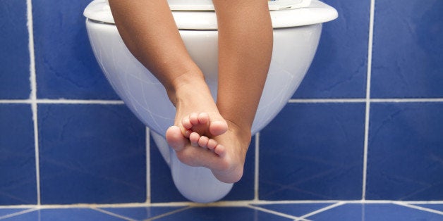 'the toddler, 3-years-old, is sitting on the toilet for toilet training potty or toiet training is the process of training a young child to use the toilet for urination and defecation.'