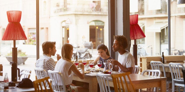 Multi-ethnic friends having lunch in restaurant