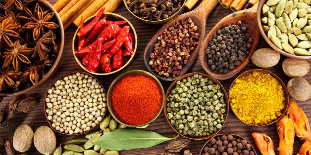 Spices and herbs in metal bowls and wooden spoons. Food and cuisine ingredients.