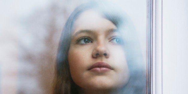 Girl looking out window