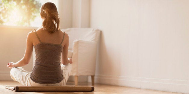 USA, New Jersey, Young woman practicing yoga