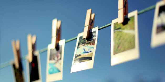 Summery pictures hanging from washing line using clothespins.