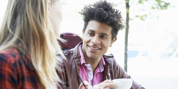 young man and woman talking in cafe