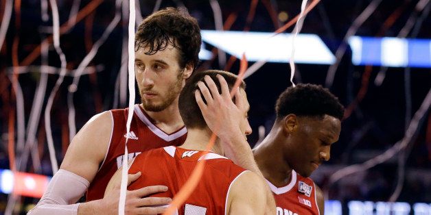 Wisconsin's Frank Kaminsky and Josh Gasser (21) react after the NCAA Final Four college basketball tournament championship game against Duke Monday, April 6, 2015, in Indianapolis. Duke won 68-63. (AP Photo/Michael Conroy)