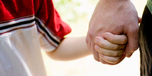 Father and son holding hands