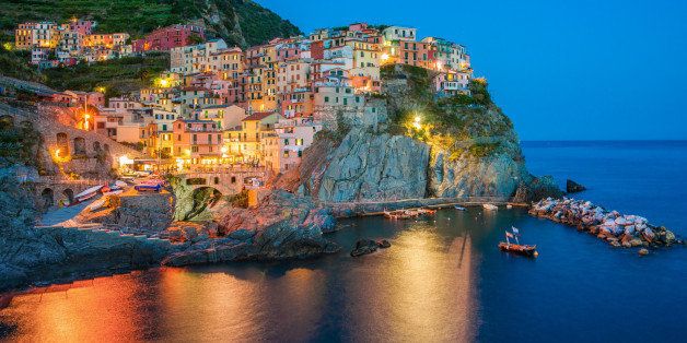 Italy, Liguria, La Spezia, Cinque Terre, Manarola, Town at dusk with electric lights