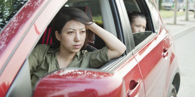 Mother and Daughter Looking Frustrated Out the Window of a Car