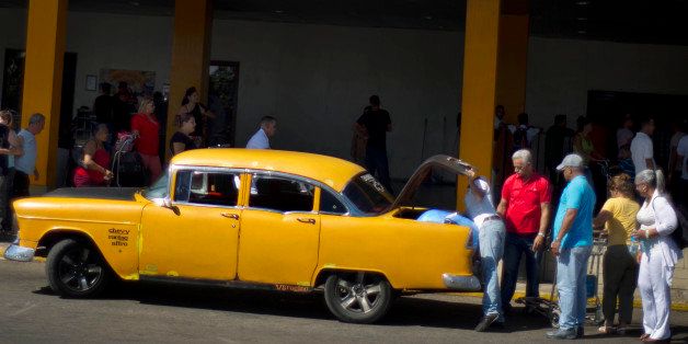 People put their luggage in a private taxi as they arrive from the U.S. to the Jose Marti International Airport in Havana, Cuba, Monday, Sept. 1, 2014. Cubans braced Monday for a clampdown on the flow of car tires, flat-screen televisions, blue jeans and shampoo in the bags of travelers who haul eye-popping amounts of foreign-bought merchandise to an island where consumer goods are frequently shoddy, scarce and expensive. (AP Photo/Ramon Espinosa)