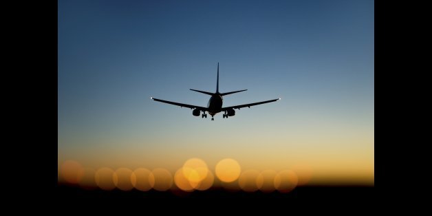 aircraft approaching airport at blue and orange sunset