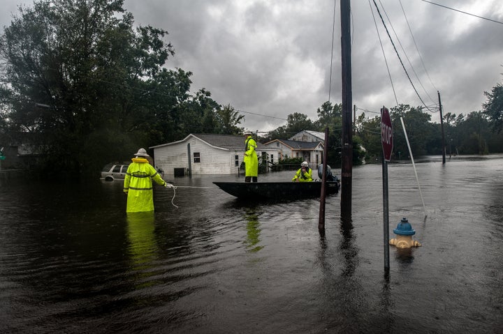 Workers with Duke Energy move through Lumberton, North Carolina, by boat in attempts to restore power to customers on Sunday after intense flooding in the town.