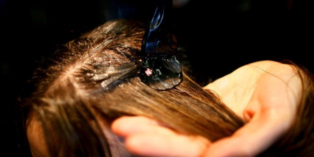 LONDON - FEBRUARY 06: A salon treatment specialist applies a treatment of bull semen and katera at Hari's Salon on February 6, 2007 in London, England. A new, alternative and intense conditioning treatment at a Chelsea hair salon, Hari's uses organic pedigree Angus bull semen, fresh from Brooklet Farm in Cheshire. The substance's pure protein, combined with katera, a protein-rich plant root, penetrates each shaft and deeply nourishes the hair. (Photo by Daniel Berehulak/Getty Images)