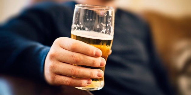 Man drinking pint of beer.