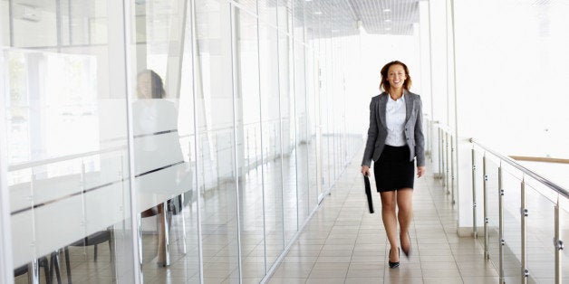 Businesswoman walking along the office corridor