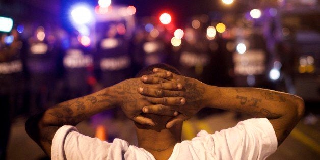 BALTIMORE, MD - APRIL 28: Protestors defy curfew and taunt police officers the night after citywide riots over the death of Freddie Gray on April 28, 2015 in Baltimore, Maryland. Freddie Gray, 25, was arrested for possessing a switch blade knife April 12 outside the Gilmor Houses housing project on Baltimore's west side. According to his attorney, Gray died a week later in the hospital from a severe spinal cord injury he received while in police custody. (Photo by Mark Makela/Getty Images)