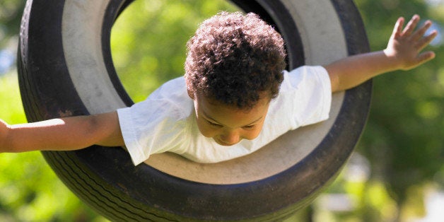 Boy on tire swing