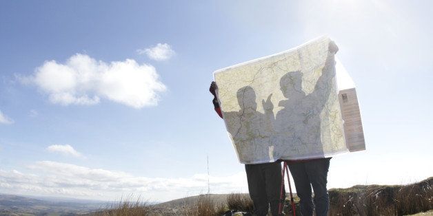 two hikers looking at map