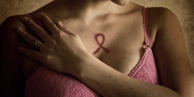 Woman in pink bra representing breast cancer awareness month.