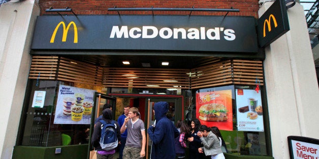 Youths gather outside a McDonald's restaurant in London, Sunday, Sept. 4, 2011. About 1,200 McDonald's restaurants in Britain will begin displaying the calorie count of each food and drink item on their wall-mounted menu boards this week, as part of a government-led program to fight obesity and promote healthier eating, the chain said Sunday. McDonald's already puts calorie information on its Web site and the back of its tray liners, but this is the first time the figures will be displayed prominently in its restaurants outside the U.S. The chain has similar calorie menu boards in New York City, which became the first in the U.S. to put a calorie posting law in place in 2008.The British program is voluntary, and relies on partnering companies to fulfill their health pledges. Other chains that have signed up to the British Department of Health calorie display program include Kentucky Fried Chicken, Pizza Hut and Starbucks. (AP Photo/Lefteris Pitarakis)