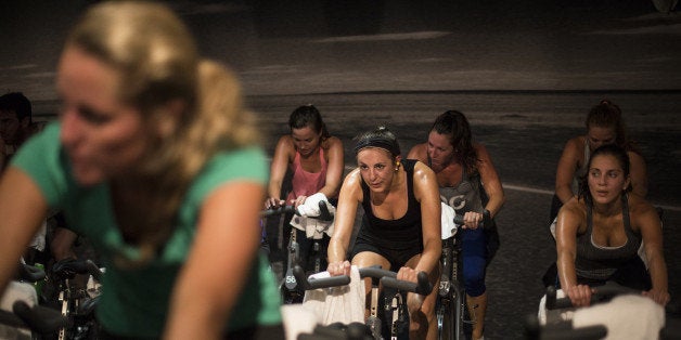 WASHINGTON, DC - AUGUST 7: Riders at SoulCycle class on Thursday, August 7, 2014 in Washington, DC. SoulCycle hosts spinning classes featuring stationary bicycles. (Photo by Yue Wu/The Washington Post via Getty Images)