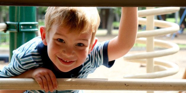 Boy looking under at Outdoor Playground
