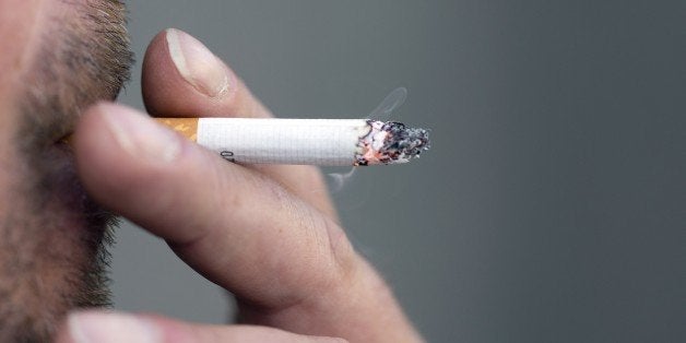 A man smokes a cigarette on May 9, 2015 in Paris. AFP PHOTO / KENZO TRIBOUILLARD (Photo credit should read KENZO TRIBOUILLARD/AFP/Getty Images)