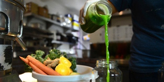 Alexander Mendez displays the juice of the 'Green Giant', which contains cucumber lemon, celery, spinach and kale, at the Silver Lake Juice Bar on September 17, 2013 in the Silver Lake district of Los Angeles, California. In the past two to three years Juice Bars have been growing in popularity and juice cleansing has become a 5 billion dollar industry nationwide, appealing to those who want to lose weight and 'detox' their bodies. AFP PHOTO/Frederic J. BROWN (Photo credit should read FREDERIC J. BROWN/AFP/Getty Images)