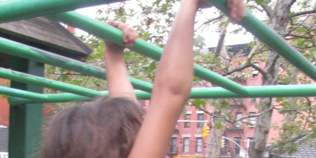 Eden on her way across the monkey bars at First Park.