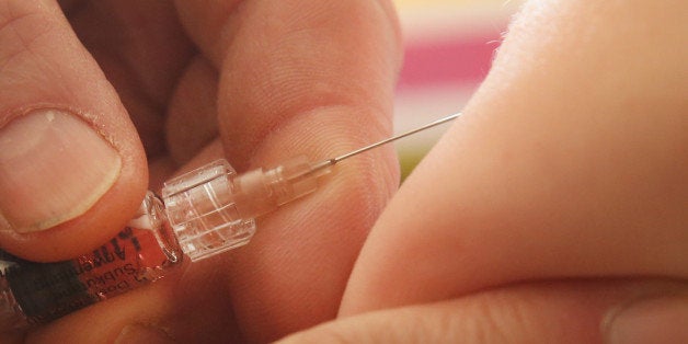 BERLIN, GERMANY - FEBRUARY 26: A children's doctor injects a vaccine against measles, rubella, mumps and chicken pox to an infant on February 26, 2015 in Berlin, Germany. The city of Berlin is facing an outbreak of measles that in recent weeks has led to over 700 cases and one confirmed death of a little boy who had not been vaccinated. Vaccination in Germany is not compulsory by law though the vast majority of parents have their children vaccinated. (Photo by Sean Gallup/Getty Images)