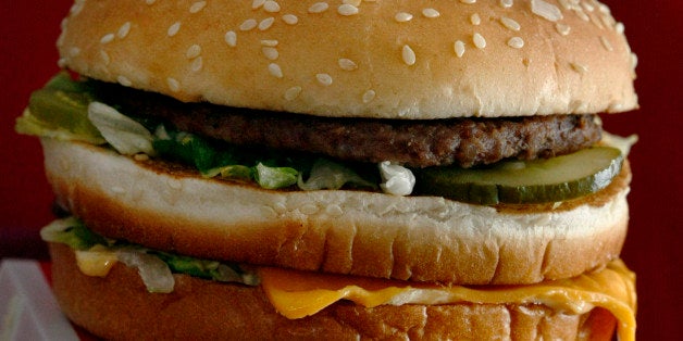 FILE - In this file photo taken Dec. 29, 2009, the McDonald's iconic Big Mac sandwich is displayed in front of one of the drinks served in a McDonald's restaurant in North Huntinton, Pa. The way Americans are chomping Big Macs, lacing up Air Jordans and gulping peppermint mochas in this abysmal economy, youᅢ까タᅡルd think theyᅢ까タᅡルre taking advantage of big holiday discounts. (AP Photo/Keith Srakocic, File)