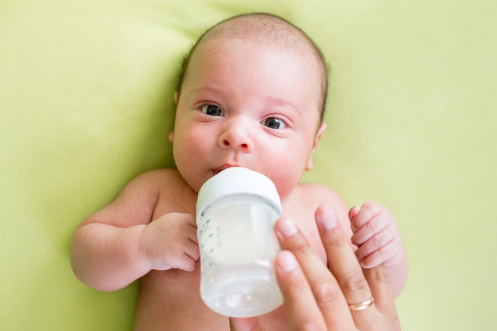 father feeding milk his baby...