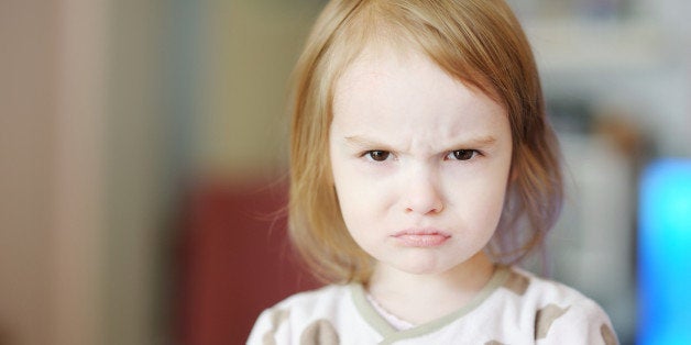 Portrait of little angry toddler girl