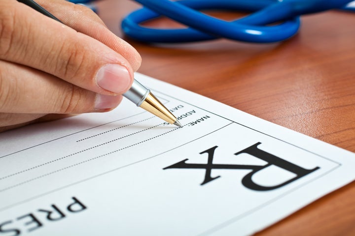 Closeup shot of a doctor writing a medical recipe