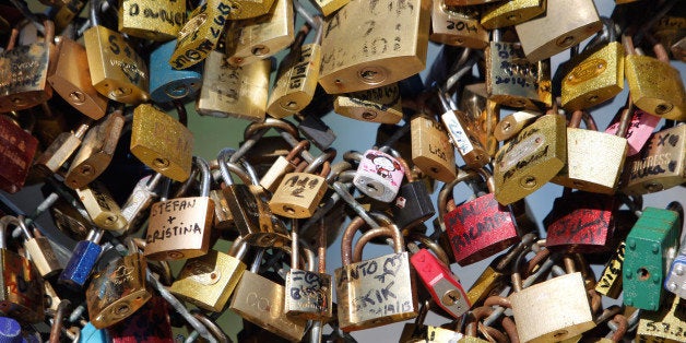 FILE - This April 9, 2014 file photo shows love locks fixed on the Pont des Arts bridge in Paris, France. Any hope that the love locks that cling to Parisᅢ까タᅡル famed Pont des Arts bridge would last forever _ will be unromantically dashed by the city council who plan to dismantle them Monday _ for good. (AP Photo/Thibault Camus, File)