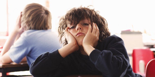 portrait of schoolboy looking bored