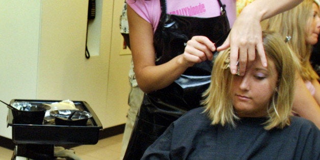 391650 02: Lorraine Connelly checks her hair in a mirror as Laura Walz gets a hair color treatment by Tey Medina at the Vidal Sasson Salon July 9, 2001 in Miami Beach, Florida. The women colored their hair blonde for National Blonde Day. The salon gave free color jobs in recognition of the day. (Photo by Joe Raedle/Getty Images)