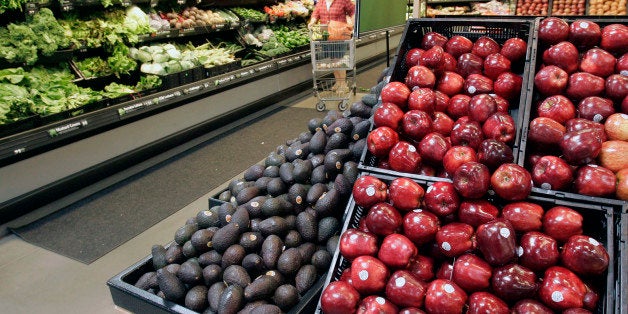 FILE - In this file photo taken April 29, 2008, a woman shops for produce in a Maumelle, Ark., Wal-Mart Stores Inc., Supercenter store. The nation's largest grocer and retailer announced steps Monday, June 3, 2013, to improve the quality of its fresh fruits and vegetables. (AP Photo/Danny Johnston, File)