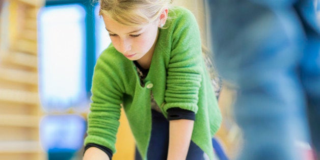 Caucasian girl working in classroom