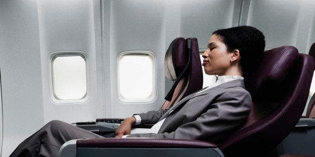 Business woman sleeping on plane, side view
