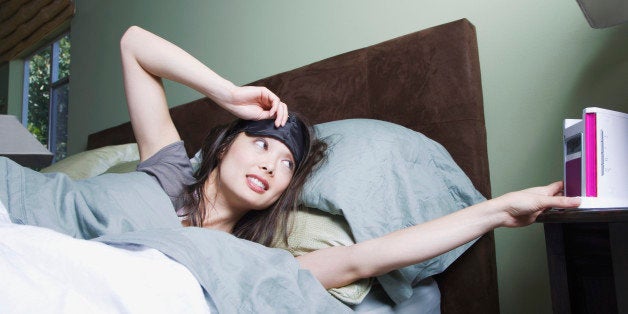 Woman waking to alarm clock