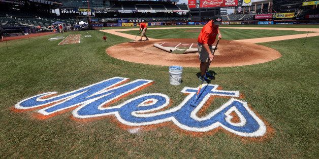 NEW YORK, NY - JULY 16: A grounds crew member paints the Mets logo on the field during the 84th MLB All-Star Game on July 16, 2013 at Citi Field in the Flushing neighborhood of the Queens borough of New York City. (Photo by Bruce Bennett/Getty Images)