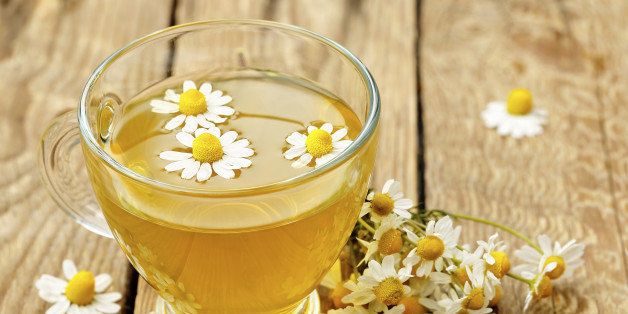 cup of chamomile tea with chamomile flowers
