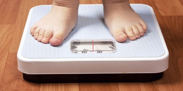 Closeup view of scales on a floor and kids feet