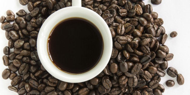 coffee beans enclosed white coffee cup isolated on white background