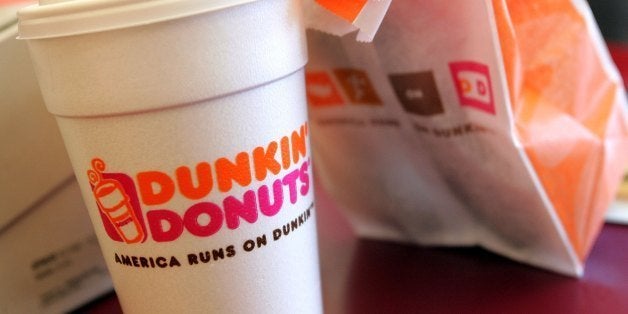 CHICAGO - SEPTEMBER 07: A cup of Dunkin' Donuts coffee and a donut bag sit on a counter September 7, 2006 in Chicago, Illinois. In an effort to compete with Starbucks in the lucrative coffee market, Dunkin? Donuts has announced a goal of opening more than 10,000 new stores in the U.S. by 2020. (Photo by Tim Boyle/Getty Images)