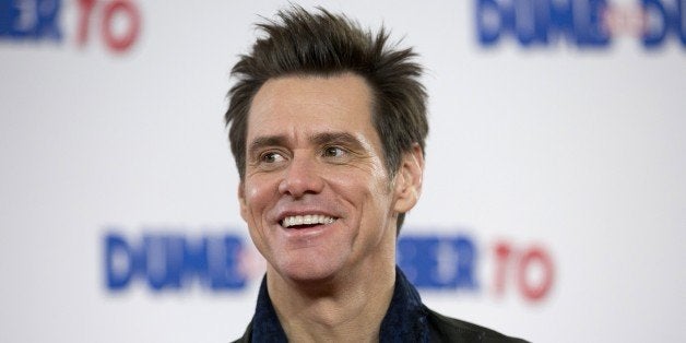 US actor Jim Carrey poses for photographers at a photocall for the film 'Dumb and Dumber To' in London on November 20, 2014. AFP PHOTO / JUSTIN TALLIS (Photo credit should read JUSTIN TALLIS/AFP/Getty Images)