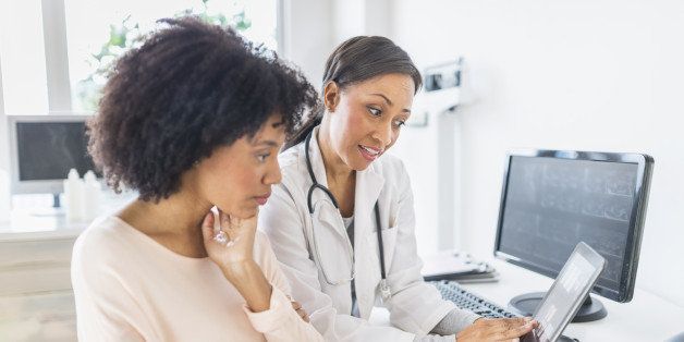 African American doctor and patient talking in office
