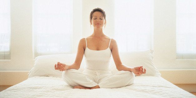 Woman Meditating in her Bedroom