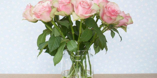 bouquet of pink roses in vase on table