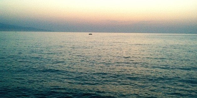 Rowboat In Sea At Dusk